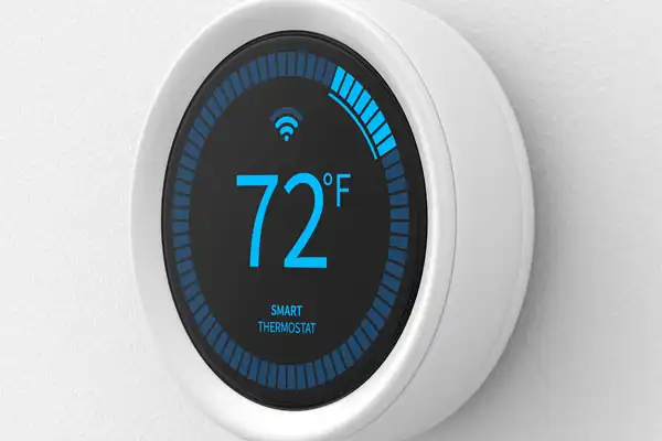 A circular smart thermostat displays the temperature as 72°F with a Wi-Fi signal icon above it and the words "SMART THERMOSTAT" below on a black screen.